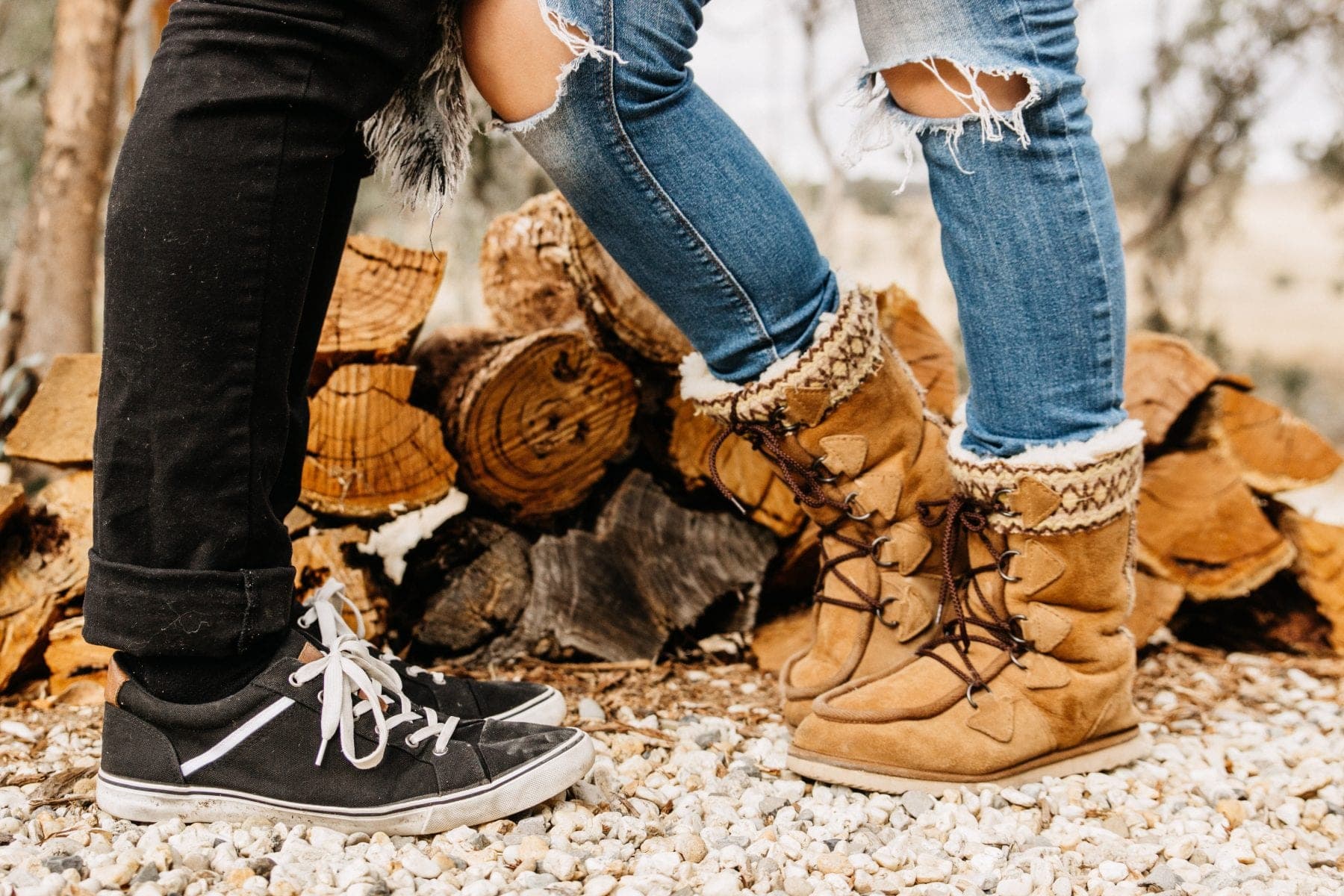 Boots up by the fire, a stack of firewood behind