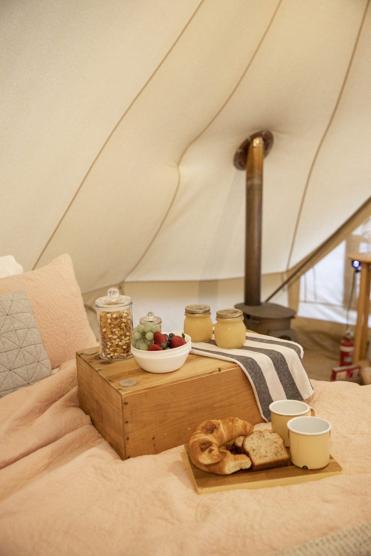 The Brekkie Box on the end of the bed inside a bell tent