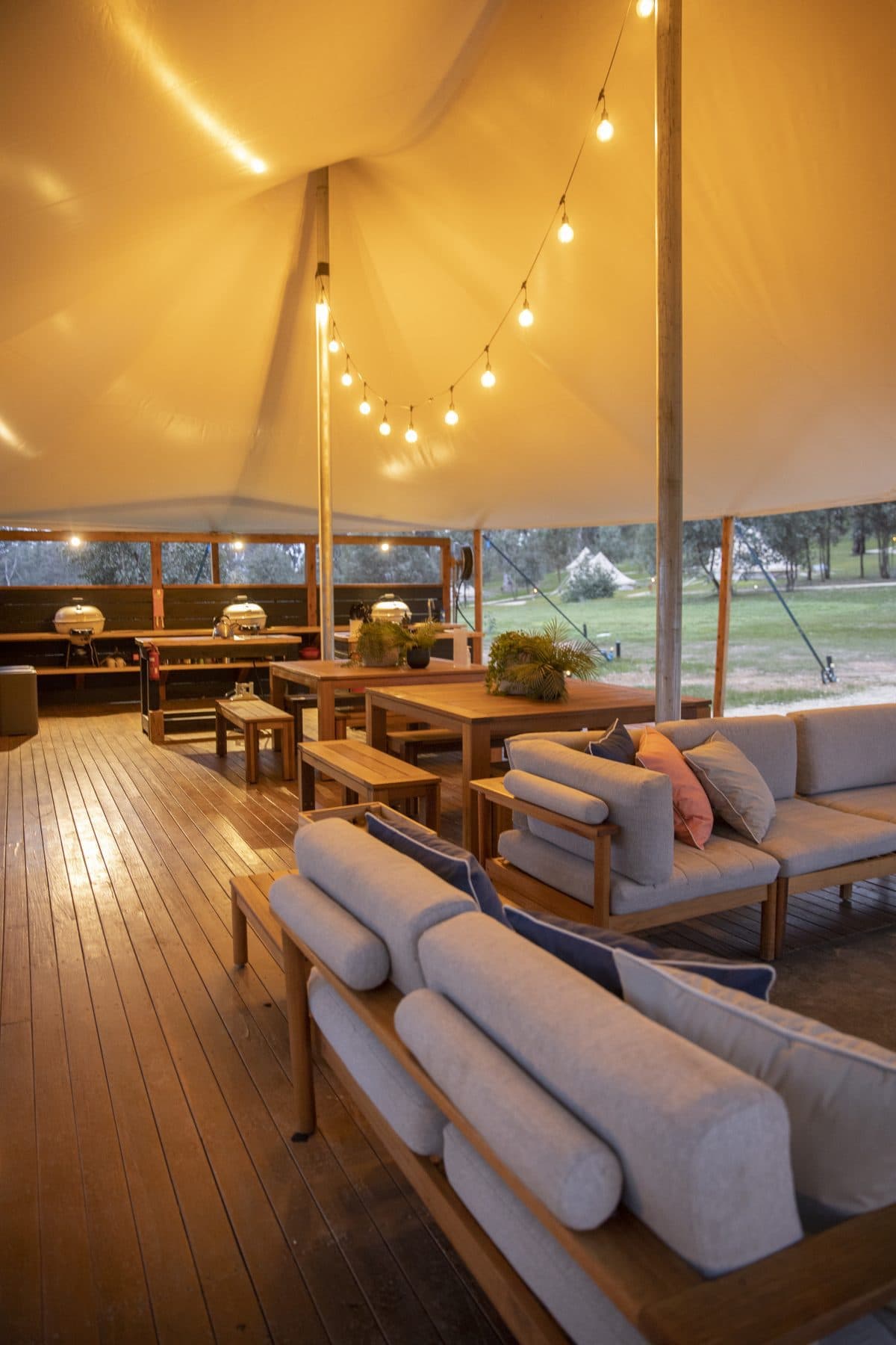 The camp kitchen deck, with lounges and a long timber dining table