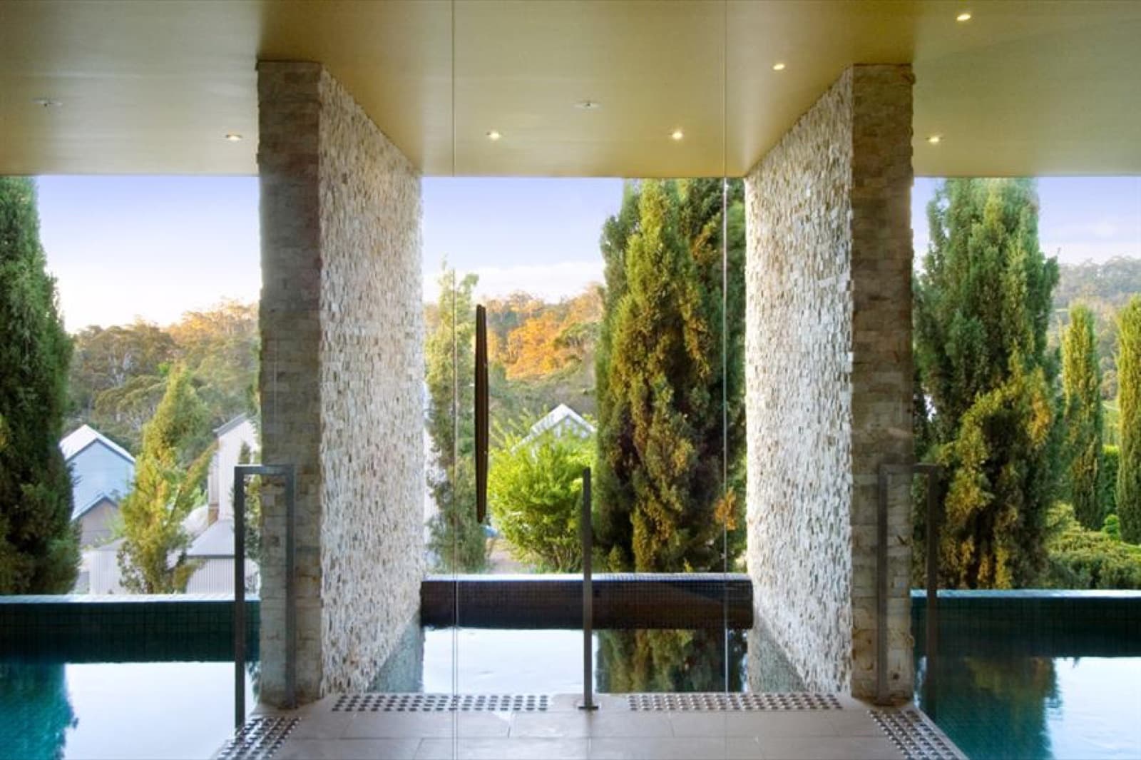 The indoor mineral pool at The Mineral Spa, stone columns opening onto the gardens