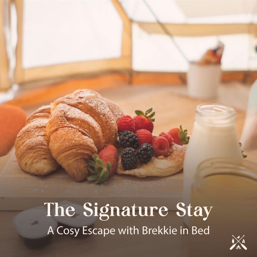 The Signature Stay — croissants, berries and juice on a board inside a bell tent