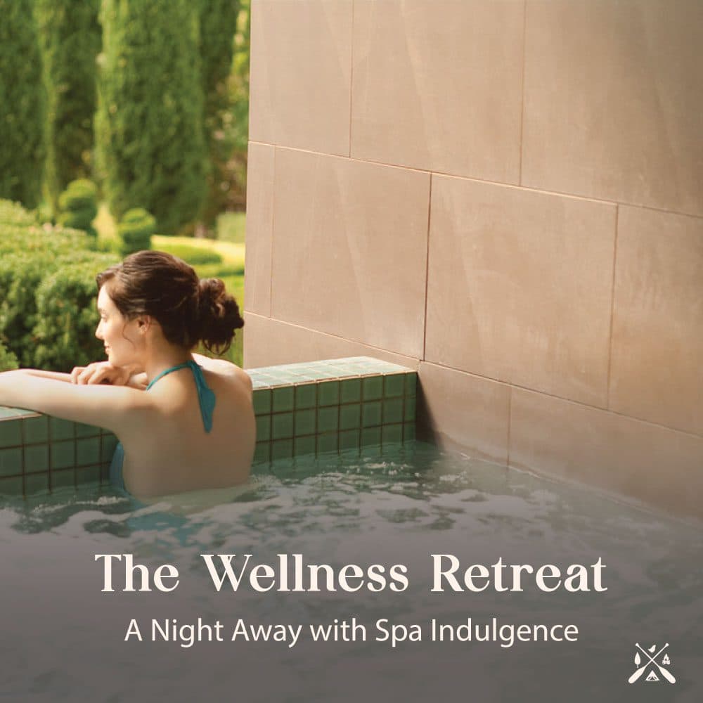 The Wellness Retreat — a guest resting at the edge of a warm mineral spa pool