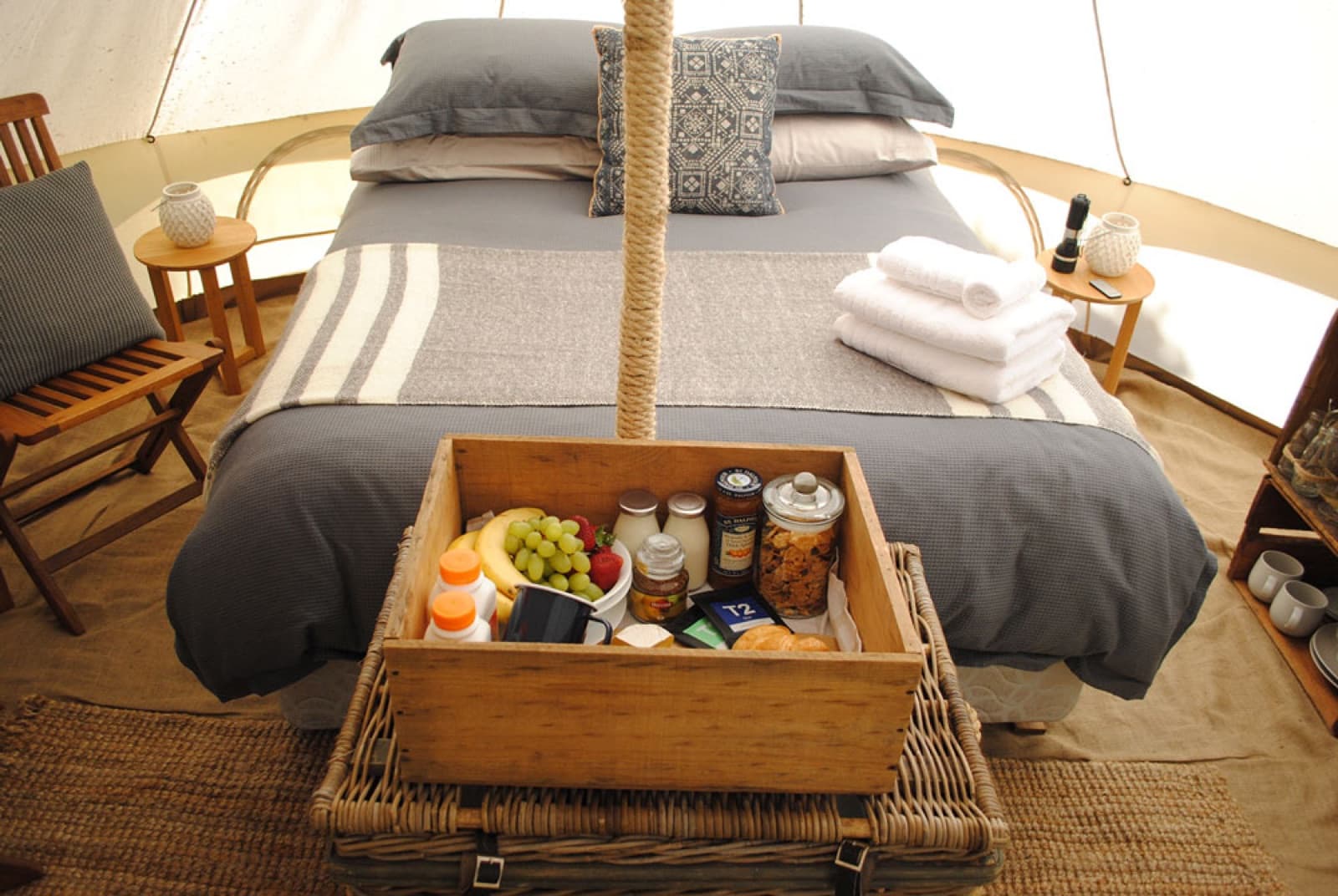 The Brekkie Box set on the end of the bed inside a bell tent